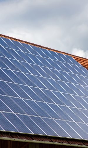 solar panels on the roof of a house. horizontal orientation, blue sky. Energy concept